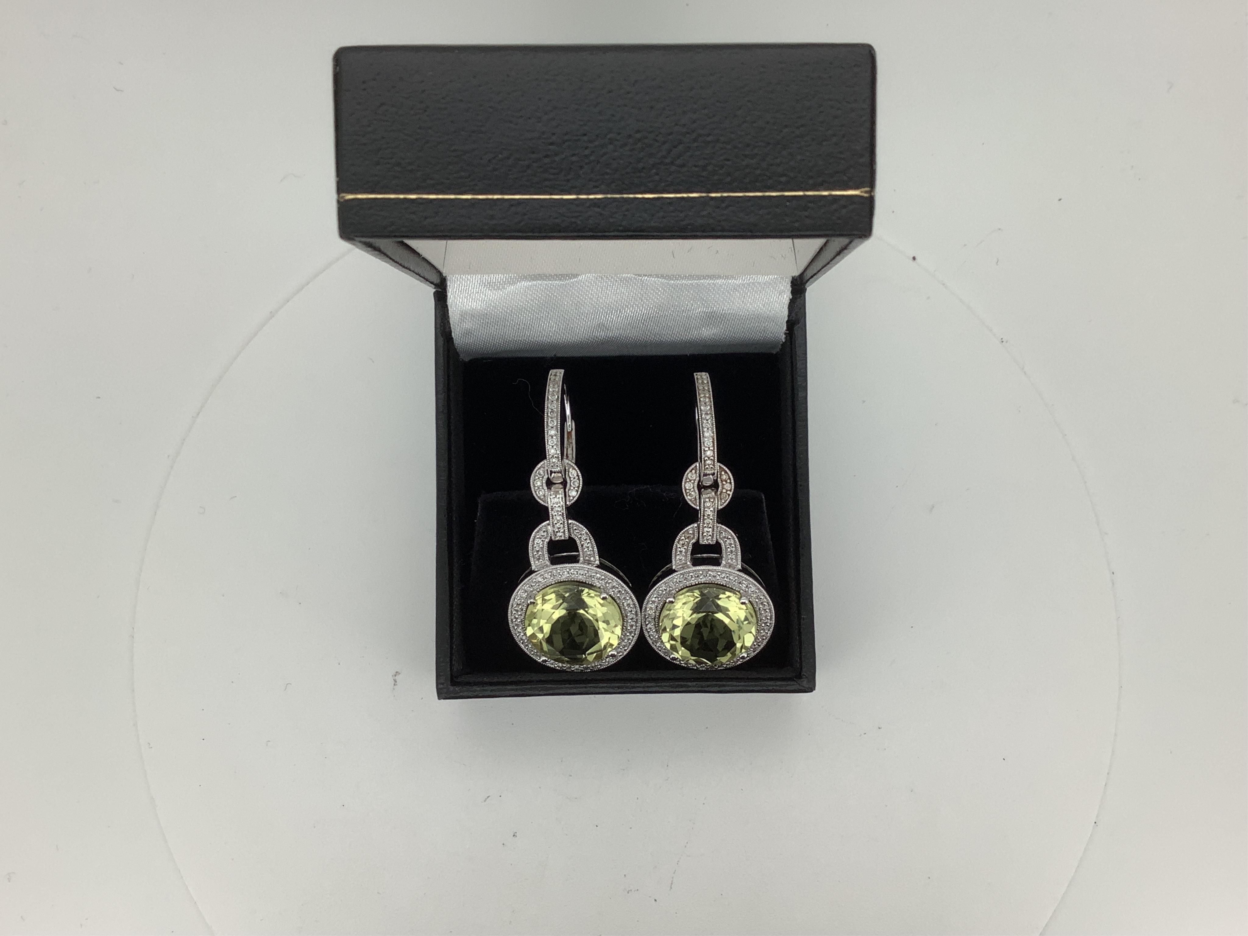 A pair of modern 18k white metal and single stone circular cut citrine set drop earrings, with diamond chip set border, links and ear wire, drop approximately 41mm, gross weight 11.6 grams, citrine diameter approximately